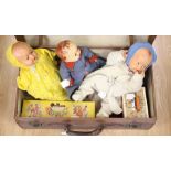 A suitcase to include; a Pinocchio Pelham Puppet, boxed, three dolls from the late 1940's and a