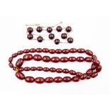 A cherry amber graduated oval bead necklace, largest bead approx 24mm x 15mm, smallest approx 12mm x
