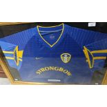 A framed, glazed and signed Leeds United away shirt, bearing Robbie Keane's signature, 65cm x 90cm