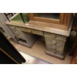 A 20th century carved oak pedestal desk, drawer handles carved as the green man