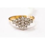 A diamond cluster ring, the diamond shaped cluster set with round brilliant cut diamonds, size V,