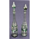 A pair of tall cut and etched glass decanters, overlay green, circa 1920's