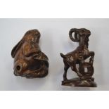A Japanese Netsuke in dark wood, the Netsuke depicts a horned mountain goat, it is in excellent