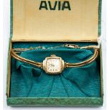 A ladies 9ct gold Avia bracelet watch, square cushion shaped champagne dial, gold tone numbers and