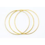 Three gold bangles, unmarked assessed as 22ct gold,  textured finish, width approx. 3mm,  internal