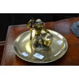 Early 20th Century brass ink stand with man with bow and a lidded inkwell