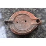 **REOFFER IN A&C NOV £20-£30** A Roman Terracotta oil lamp with heart shaped nozzle, oval body