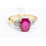 A ruby and diamond ring, the claw set oval set ruby measuring approx. 8mm x 6mm, diamond set bands