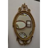 Gilded oval wall mirror