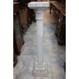 An early 20th Century stone pedestal stand, square top above circular stone carve decoration with