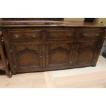 A Victorian oak three door drawer sideboard.