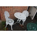A 20th century cast metal garden furniture, two chairs and one table