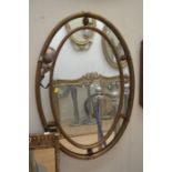 A 20th Century gilt wood oval inlay mirror; A similar mahogany mirror. (2)