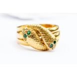 An 18ct gold  serpent ring, comprising double headed serpent, engraved scales and paste set green