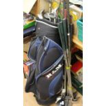 A collection of assorted golf clubs and a pair of Elan skis