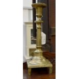 A late 17th/early 18th Century brass candlestick on stile feet