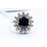 A sapphire and diamond cluster ring, comprising central oval sapphire approx. 10mm x 8mm, with a