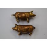 A pair of early 20th Century metal novelty vesta cases in the form of pigs