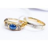 A sapphire and diamond 9ct yellow and white gold ring, cabochon oval stone with diamond accents