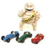 A vintage cast metal promotional Michelin Man model and three 1950's Dinky Toys sports cars