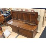 A early George III oak settle, circa 1860, four rectangular panelled back rest, under seating