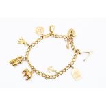A 9ct gold charm bracelet with various 9ct gold and rolled gold charms, including a Masonic charm,