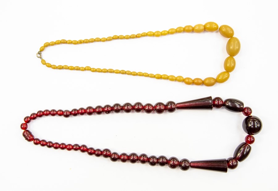 A vintage cherry coloured bead necklace, with graduated round and cone shaped beads, possibly