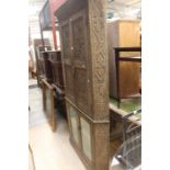 A 20th century french style oak corner cupboard, carved inlay doors above glazed inlay cabinet.