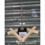 White metal crucifix on stand with two ivory crucifixes