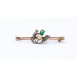A Edwardian emerald, diamond and pearl brooch in the form of a thistle, platinum setting with