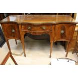 A Georgian  mahogany serpentine sideboard with glass top