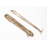 An Edwardian 9ct long guard chain, length approx. 62" and a 9ct fancy link watch chain, length