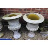 A pair of 19th century marble carved urns, egg and dart rim, turned column on a circular base.