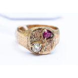 A gents 9ct gold ruby and diamond ring, cushion shaped top set with an  old cushion cut diamond