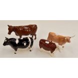 A group of Beswick cattle statues including CH of Champions, two brown cows and brown and a white