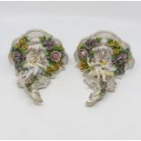 A pair of late 20th Century Dresden wall sconces with cherub and floral relief detail, 17 cms high