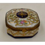 A Limoges porcelain ormolu mounted octagonal pill box white ground decorated with flowers and gilt