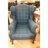 Tartan wing back arm chair, raised on Cabriole supports.