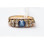 A Victorian and diamond set ring, the central cushion cut sapphire approx 0.45ct, with five old