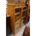 A pine glazed bookcase in the Victorian style.