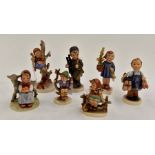 A group of seven Hummel figures including a girl with a dog and slipper, S6/B