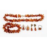 **REOFFER IN A&C NOV £120-£160** An amber necklace, and another string, a pair of earrings, ring and