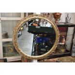 **AWAY** A modern giltwood circular mirror in the manner of French 19th century.