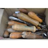 A collection of vintage push tin can openers, the majority with turned wooden handles, some with