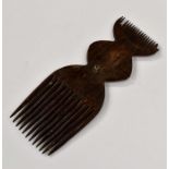 **AWAY** A tribal carved comb