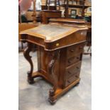 An early Victorian Burr Walnut Davenport, circa 1860, a gallery on top with a lifting lid with