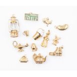 Thirteen assorted charms, comprising nine 9ct gold versions, with a combined total gross weight