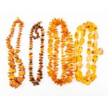 A collection of various amber bead necklaces, comprising pear shaped and chip style beads, total