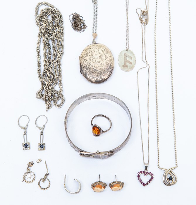 A silver and amber dress ring; a silver heart shape pendant set with rubies; a silver cuff bangle