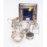 A collection of early 20th Century silver including a matching sugar bowl and cream jug, on three